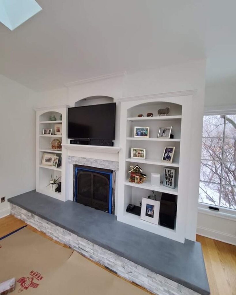 Fireplace with cabinets and photos
