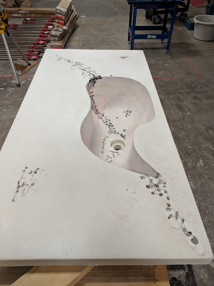 A custom whale-shaped concrete sink