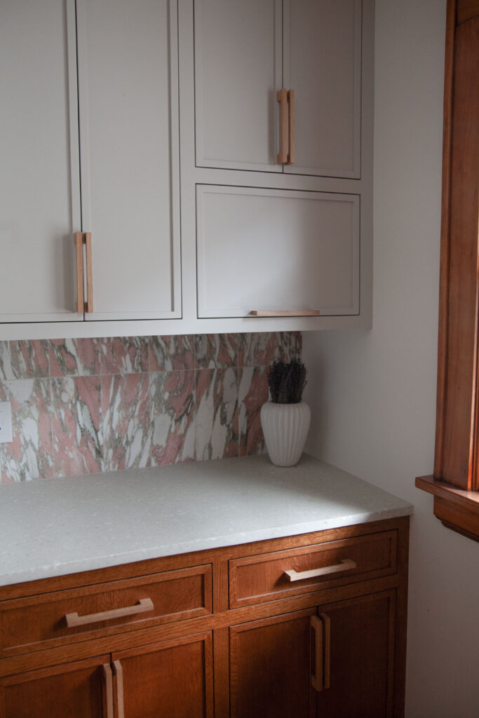 Kitchen with a pink tile backsplash and concrete terrazzo countertops