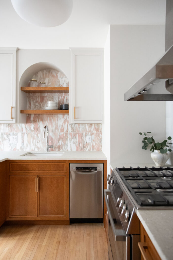 Kitchen with a pink tile backsplash and concrete terrazzo countertops