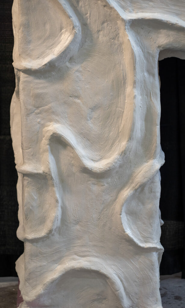 White concrete bougie fireplace surround