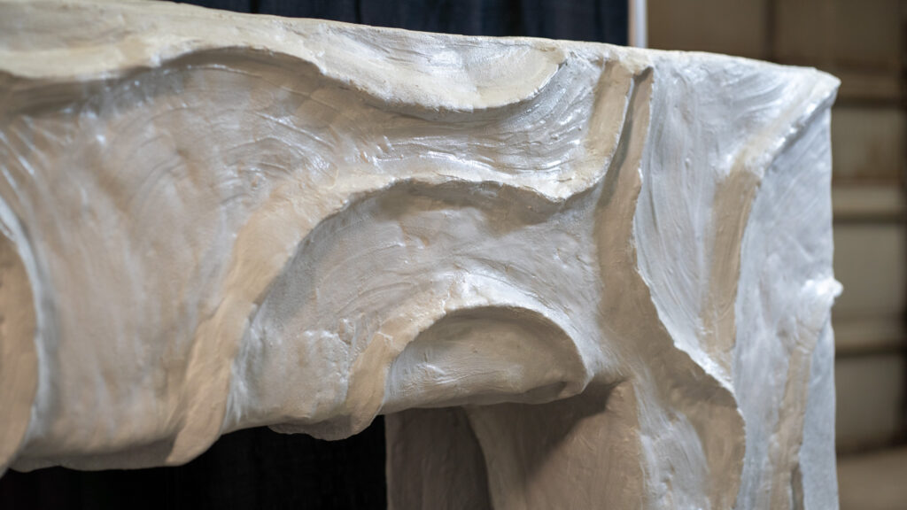 White concrete bougie fireplace surround