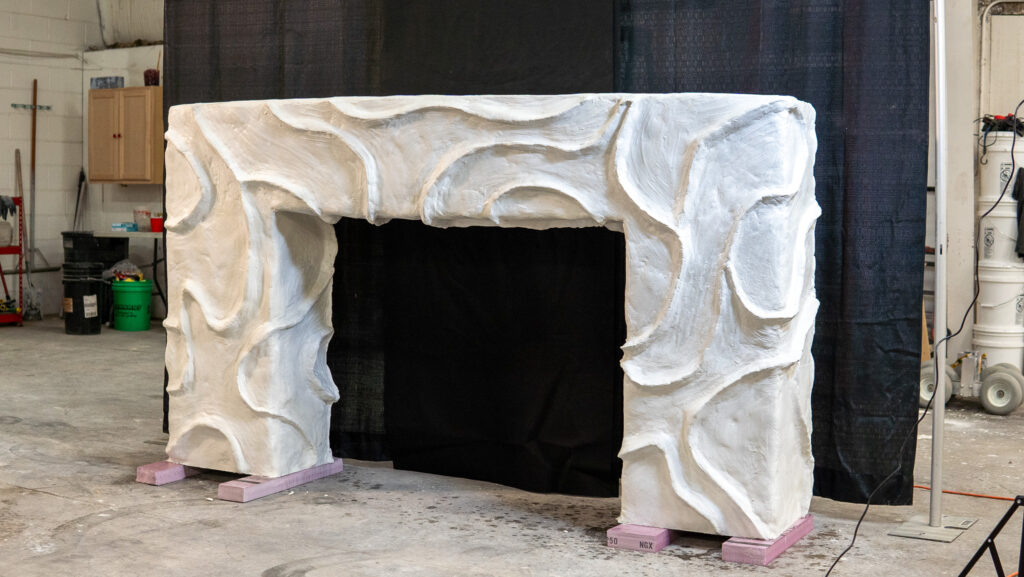 White concrete bougie fireplace surround