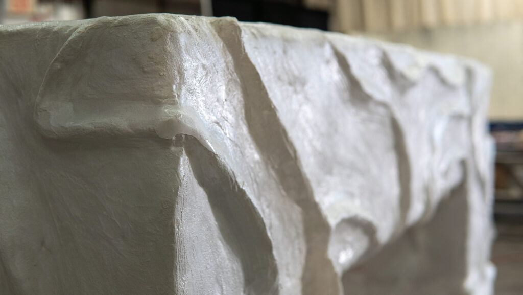 White concrete bougie fireplace surround