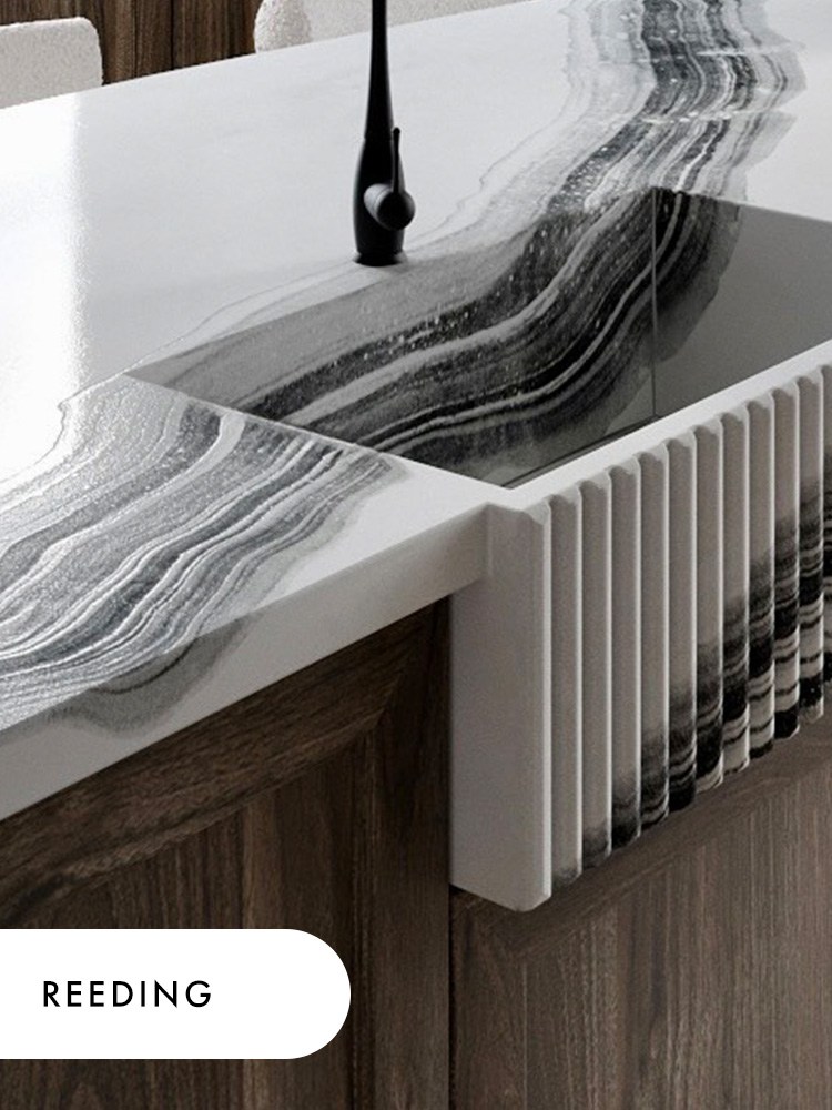 A reeded concrete farmhouse sink in the Gratitude pattern