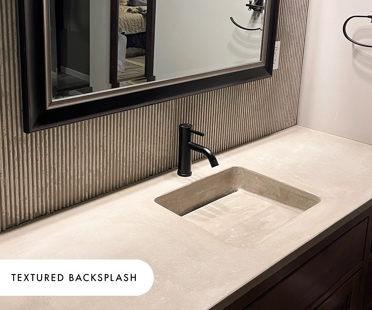 A textured concrete backsplash in the Purity pattern