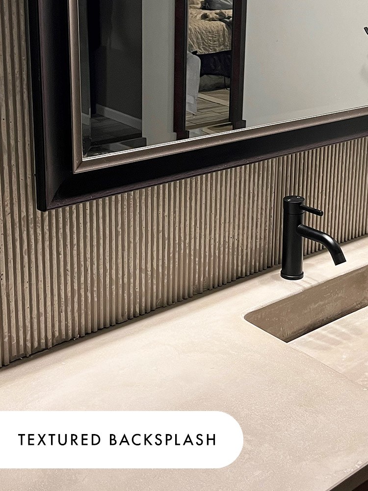 A textured concrete backsplash in the Purity pattern