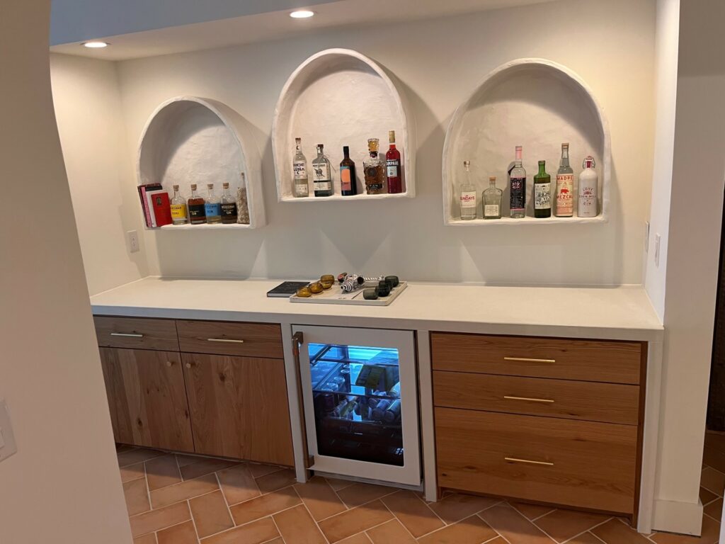 Basement dry bar with handmade concrete arches