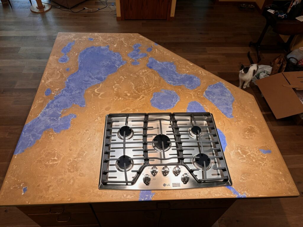 Concrete kitchen island that looks like a map of the surrounding area