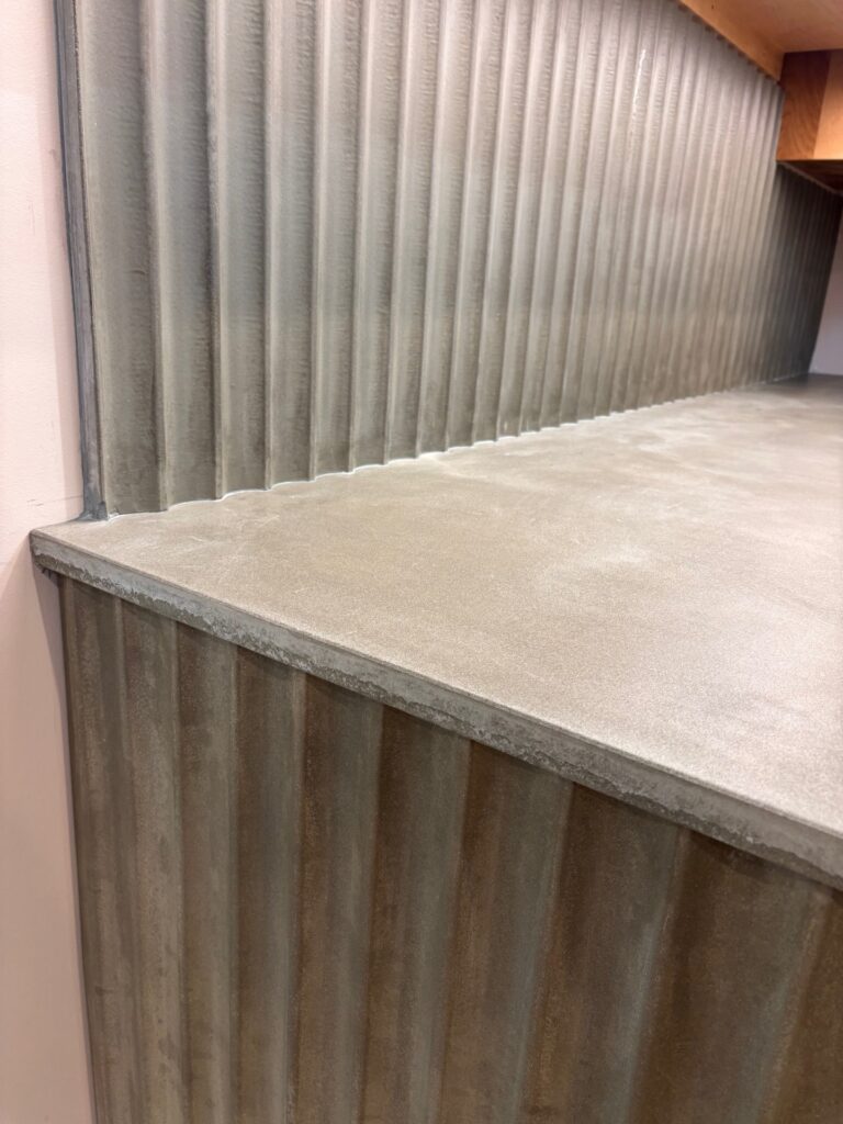 Slate green concrete countertops with fluted backsplash