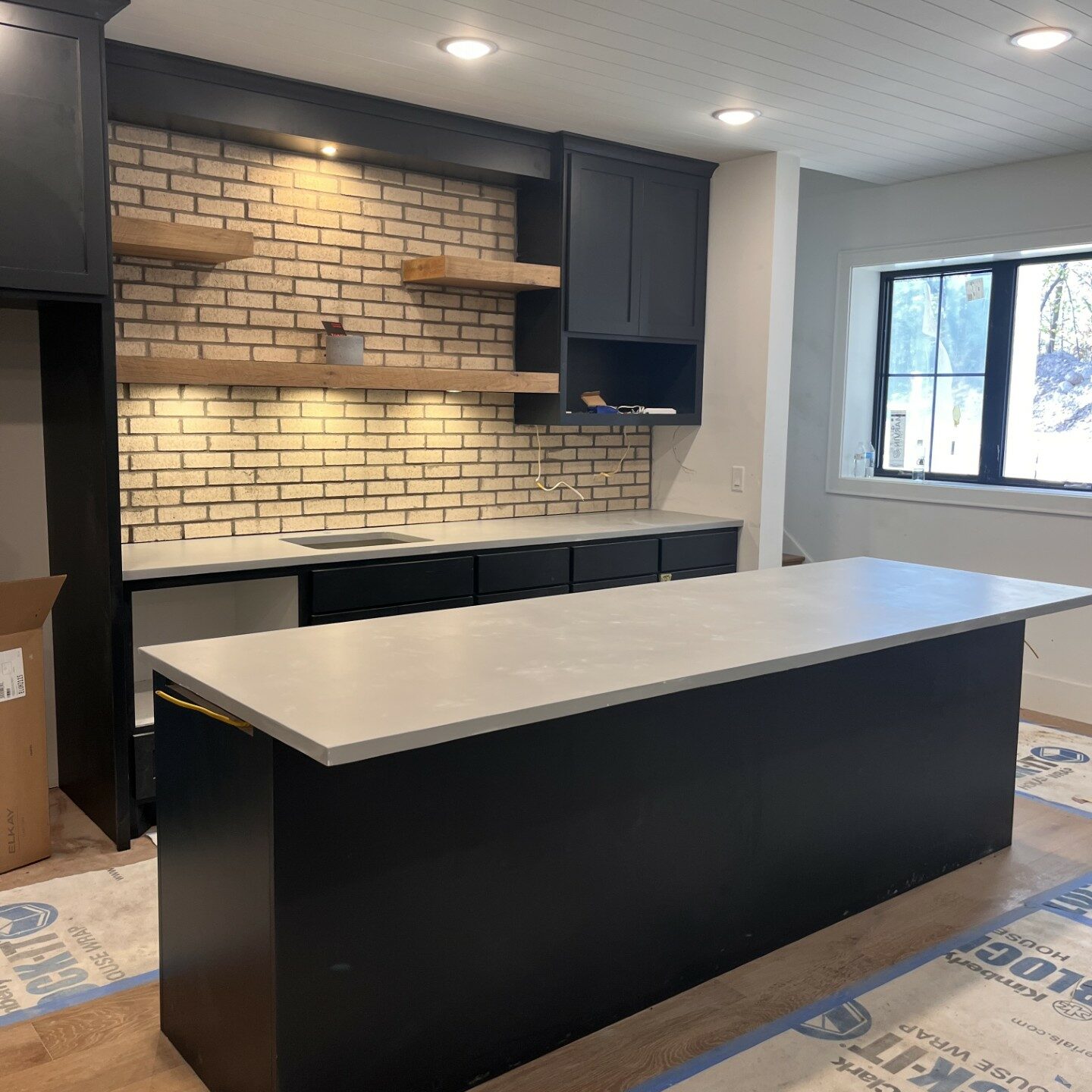 View of grey concrete countertops in a basement bar