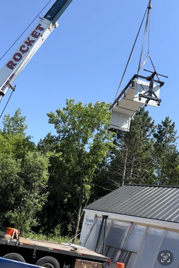 Crane lifting concrete island into the house