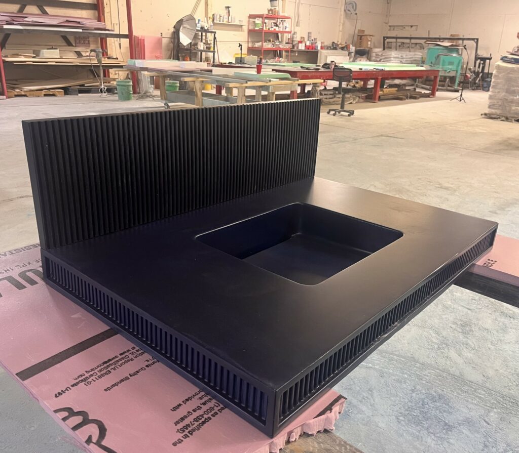 Dark blue fluted bathroom vanity with fluted backsplash