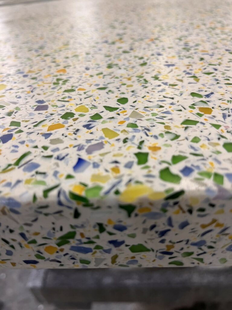 White concrete terrazzo with yellow, blue and green glass